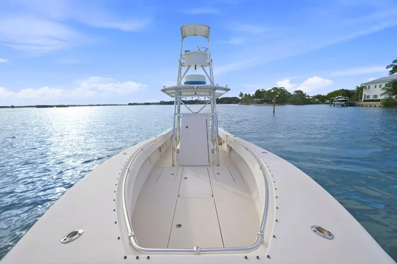 Slide: The Image of 2002 Contender 31 Open boat on calm water under a clear blue sky. - 15