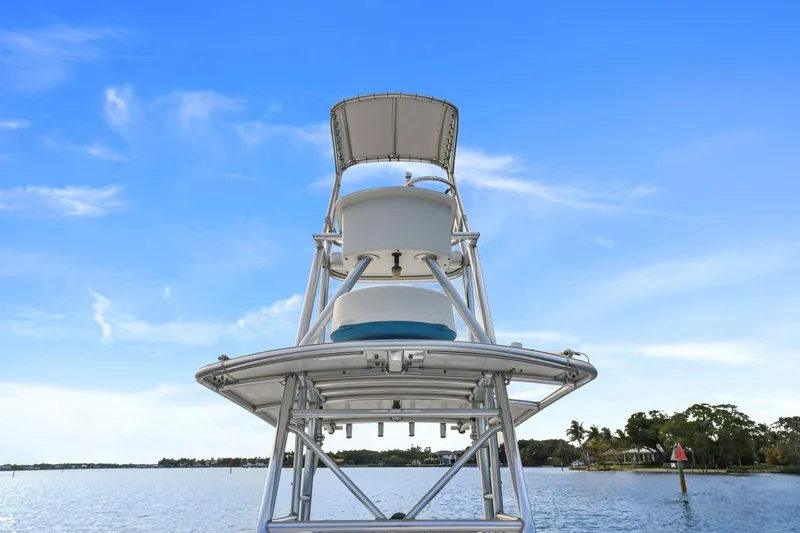 Slide: The Image of 2002 Contender 31 Open boat tower against a clear blue sky and calm water. - 16