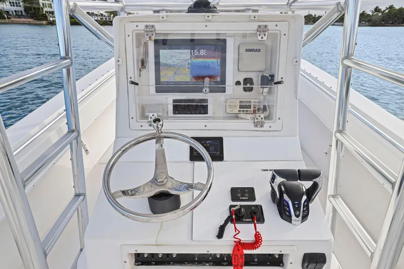 Slide: The Image of Center console of a 2002 Contender 31 Open boat with navigation equipment. - 23