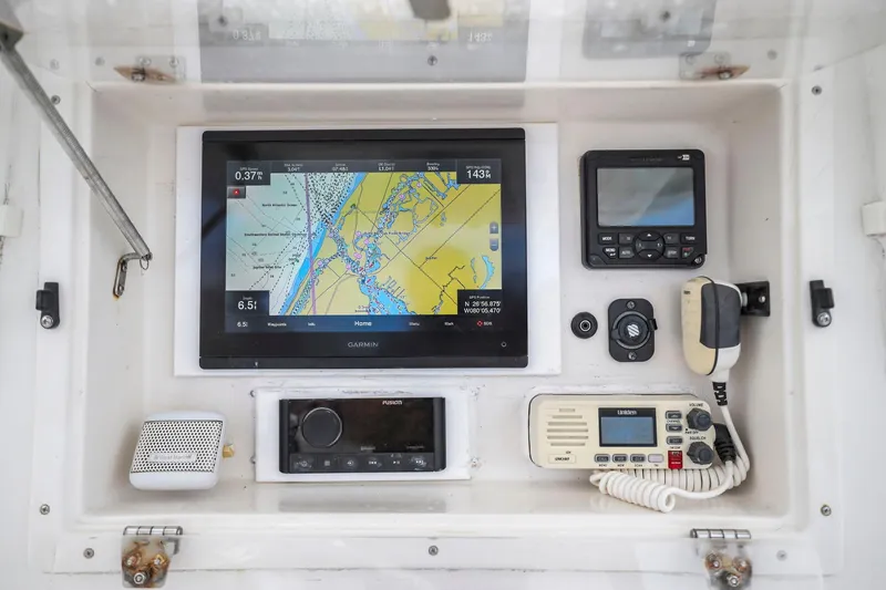 Slide: The Image of Navigation and communication equipment on a 2002 Contender 31 Open boat dashboard. - 25