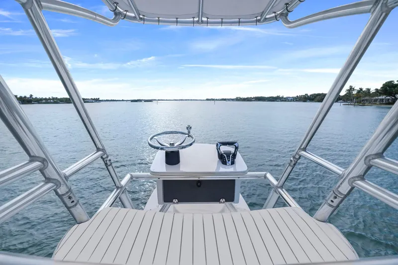 Slide: The Image of Helm view from 2002 Contender 31 Open boat on calm water under blue sky. - 26
