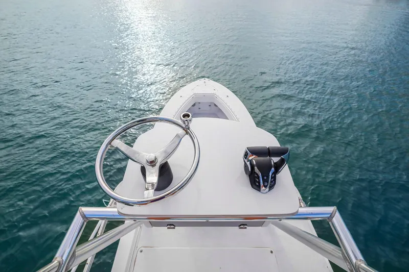 Slide: The Image of Helm view of 2002 Contender 31 Open boat on calm water. - 27