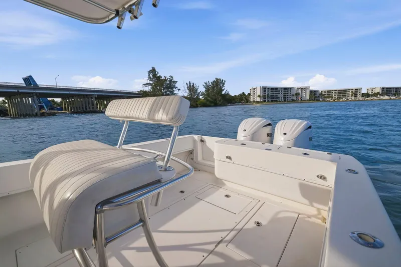 Slide: The Image of 2002 Contender 31 Open boat with dual engines, scenic waterfront view, and modern seating. - 29