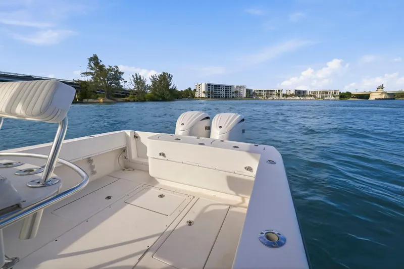 Slide: The Image of 2002 Contender 31 Open boat on water, featuring dual Yamaha engines, with coastal buildings in background. - 30