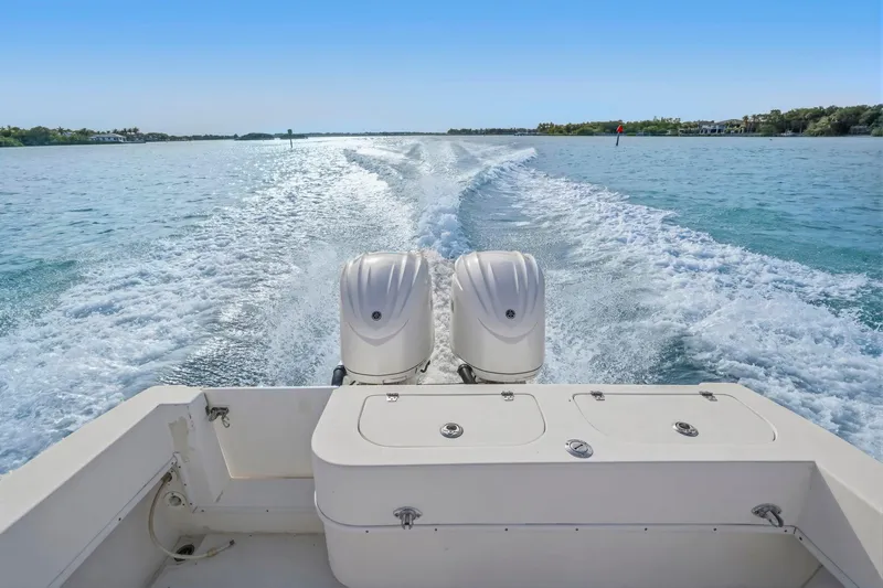 Slide: The Image of 2002 Contender 31 Open boat cruising on clear blue water, leaving a wake behind. - 33
