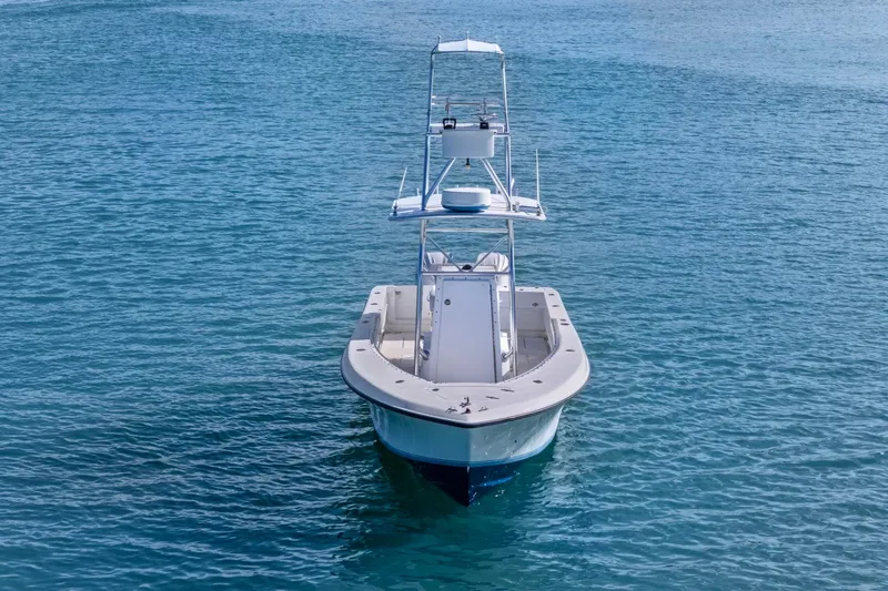 Slide: The Image of 2002 Contender 31 Open boat on calm blue water, front view. - 4