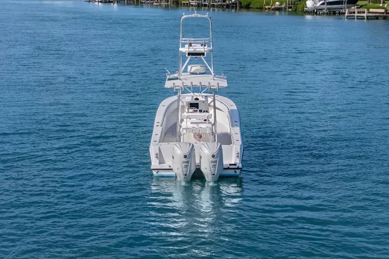 Slide: The Image of 2002 Contender 31 Open boat on calm blue water, rear view. - 6