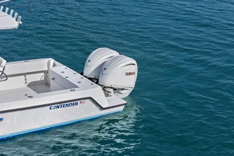 Slide: The Image of 2002 Contender 31 Open boat with Yamaha outboard engines on blue water. - 7