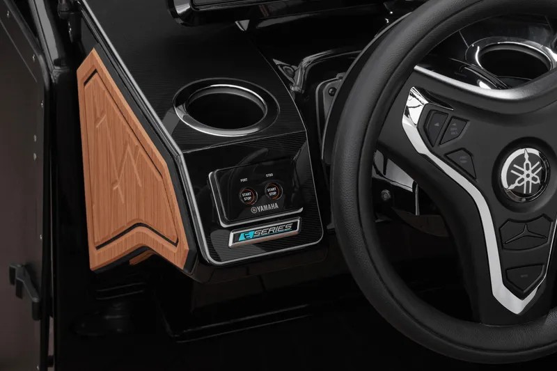 Slide: The Image of 2026 Yamaha Boats 255XD steering wheel and dashboard with modern controls and wood accents. - 13