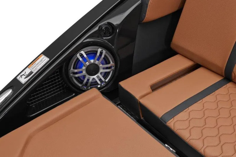 Slide: The Image of 2026 Yamaha Boats 255XD interior with brown seating and built-in speaker system. - 14