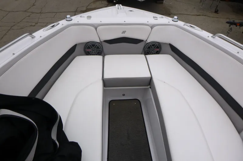 Slide: The Image of Interior of 2017 Four Winns H260 boat with white cushioned seating and speakers. - 10