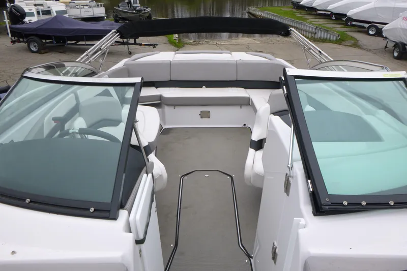 Slide: The Image of 2017 Four Winns H260 boat interior with spacious seating and dual windshields. - 11