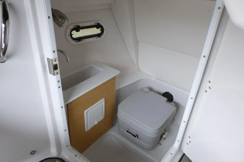 Slide: The Image of Compact bathroom in 2017 Four Winns H260 boat with sink and portable toilet. - 13