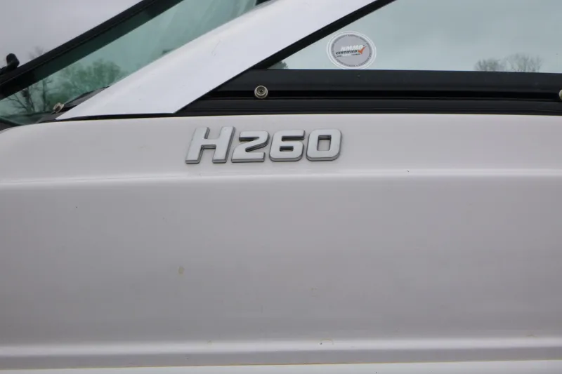 Slide: The Image of 2017 Four Winns H260 boat model emblem on white surface. - 3