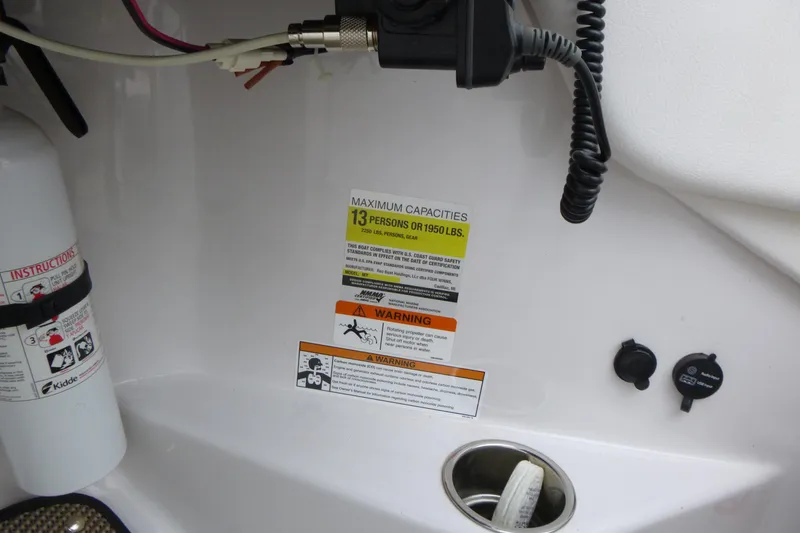 Slide: The Image of 2017 Four Winns H260 boat capacity label, fire extinguisher, and warning signs. - 9