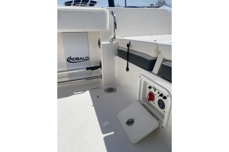 Slide: The Image of 2023 Robalo R230 Center Console boat interior with storage and control panel. - 10