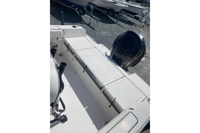 Slide: The Image of 2023 Robalo R230 Center Console boat with outboard motor, docked on gravel. - 11