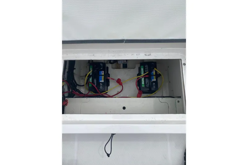 Slide: The Image of 2023 Robalo R230 Center Console battery compartment with wiring. - 14