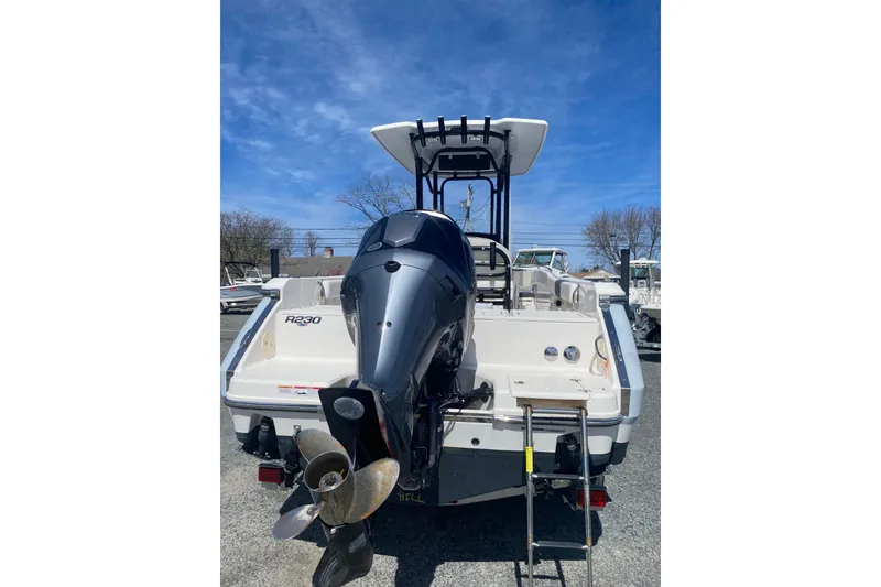 Slide: The Image of 2023 Robalo R230 Center Console boat with powerful outboard motor, rear view. - 3