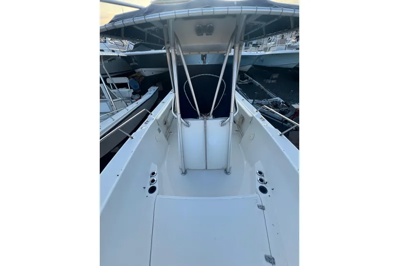 Slide: The Image of 1998 Boston Whaler Outrage 23 boat interior with center console and seating area. - 10