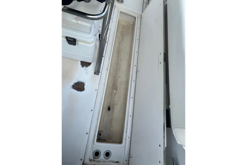 Slide: The Image of Interior view of a 1998 Boston Whaler Outrage 23 boat, showing storage compartment. - 15