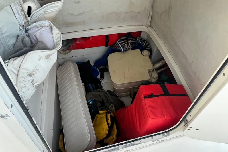 Slide: The Image of Storage compartment of a 1998 Boston Whaler Outrage 23, filled with boating gear. - 16