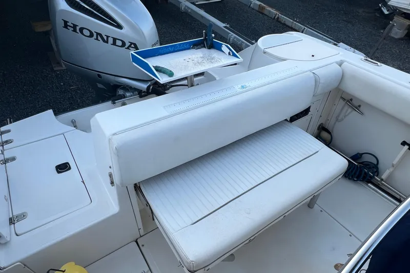 Slide: The Image of 1998 Boston Whaler Outrage 23 boat interior with Honda outboard motor. - 18
