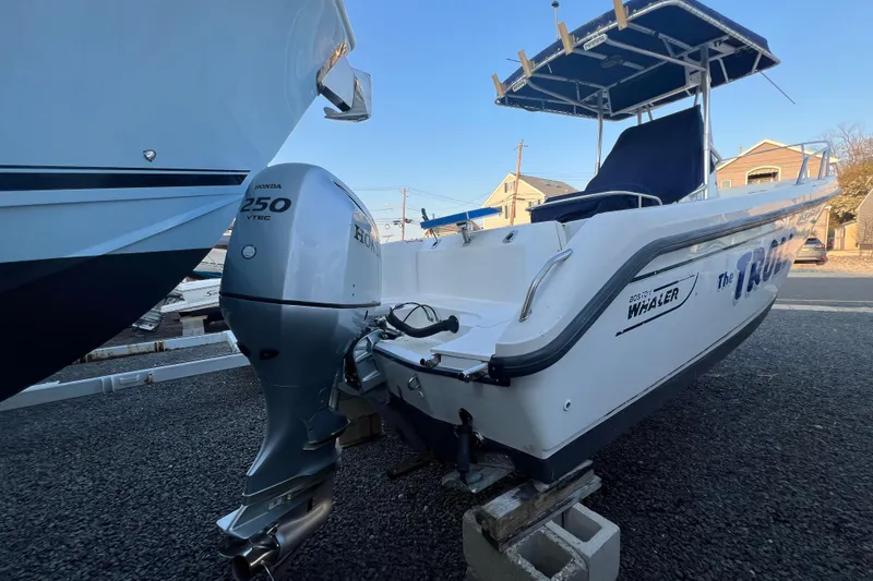 Slide: The Image of 1998 Boston Whaler Outrage 23 boat with Honda 250 VTEC engine on display. - 3