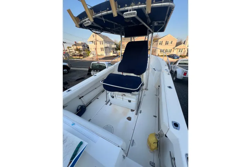 Slide: The Image of 1998 Boston Whaler Outrage 23 boat interior with blue seating and canopy. - 5