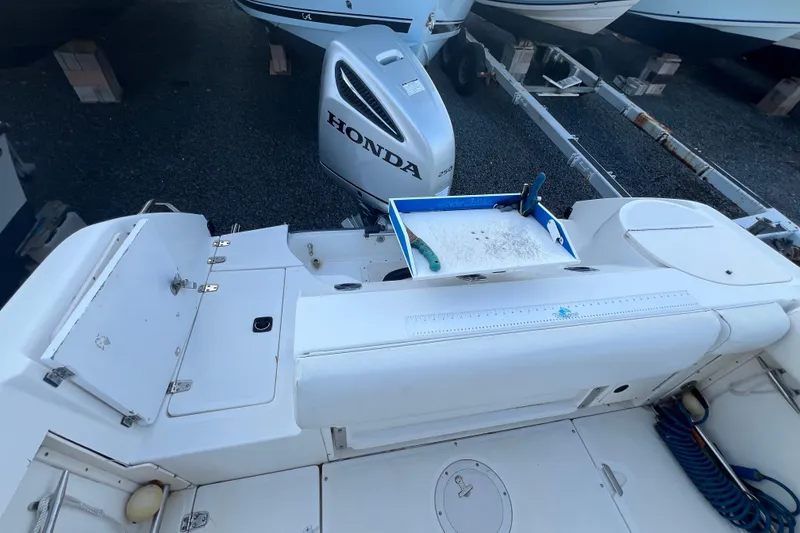 Slide: The Image of 1998 Boston Whaler Outrage 23 boat interior with Honda outboard motor. - 6