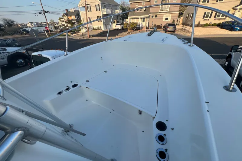 Slide: The Image of 1998 Boston Whaler Outrage 23 boat deck, featuring spacious seating and rod holders. - 8