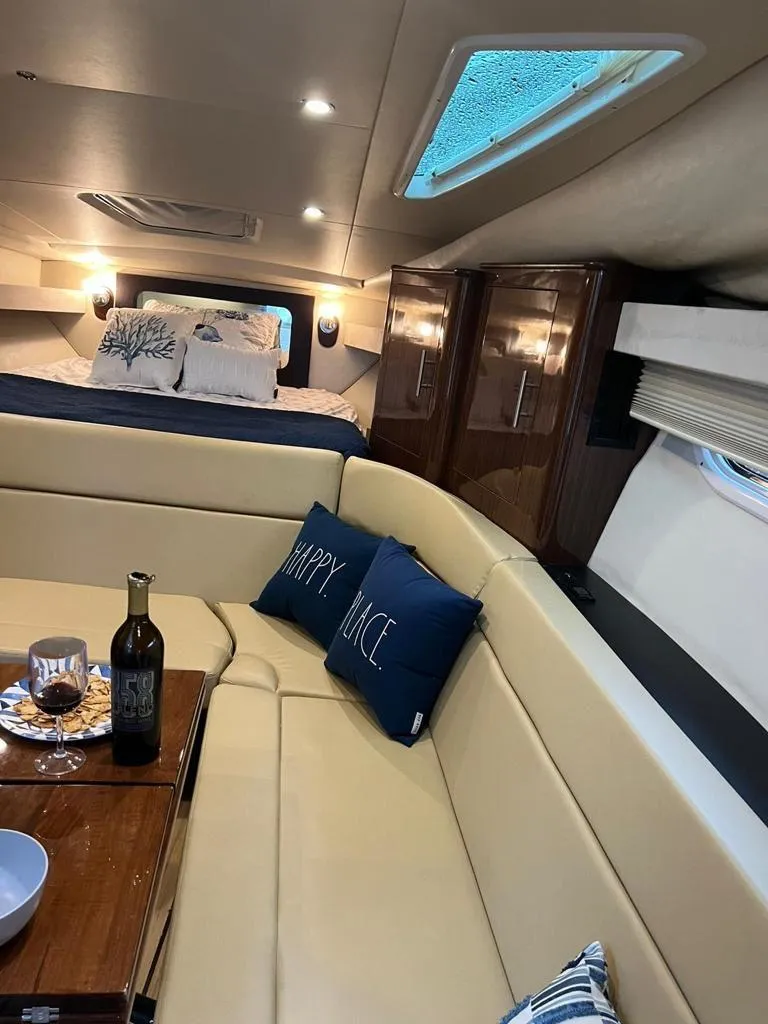 Slide: The Image of Luxurious interior of 2015 Regal 35 Sport Coupe yacht with cozy seating and elegant decor. - 17