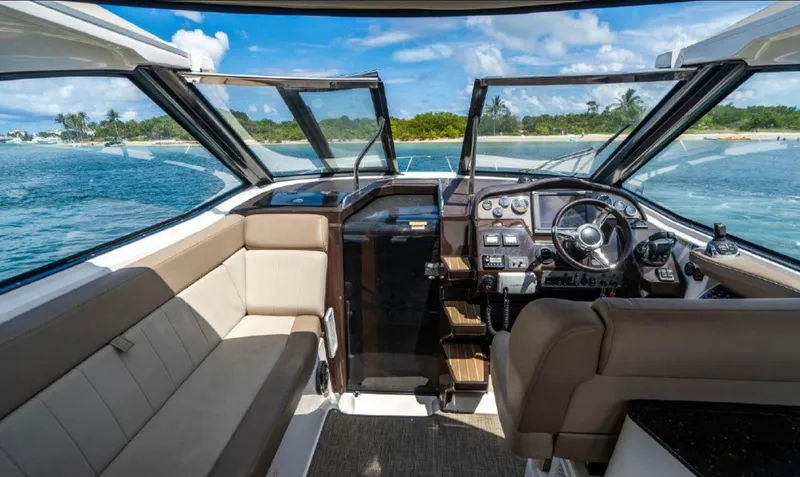 Slide: The Image of Interior of 2015 Regal 35 Sport Coupe boat with open cockpit and ocean view. - 3