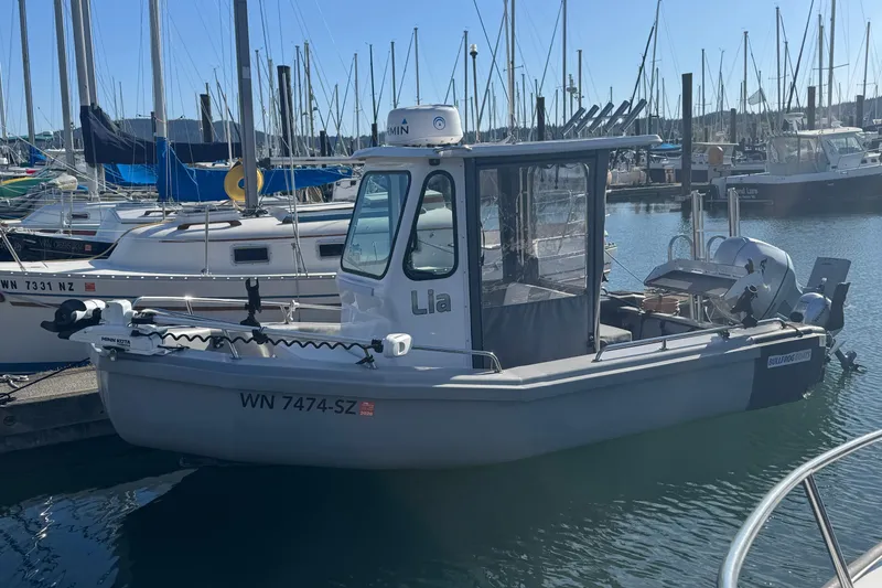 Slide: The Image of 2022 Bullfrog 17ft Pilot House boat docked in a marina with other vessels. - 3