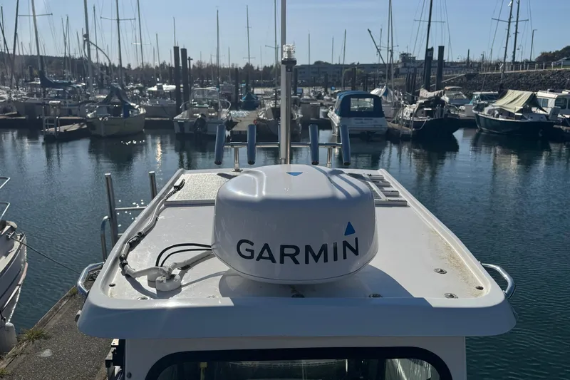 Slide: The Image of 2022 Bullfrog 17ft Pilot House with Garmin equipment in a marina setting. - 8