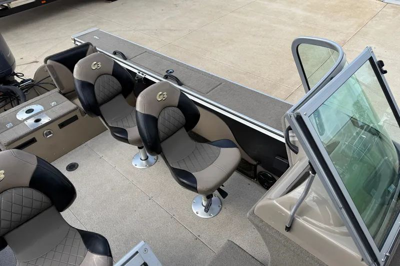 Slide: The Image of 2013 G3 Angler V185 SF boat interior with cushioned seats and windshield. - 12