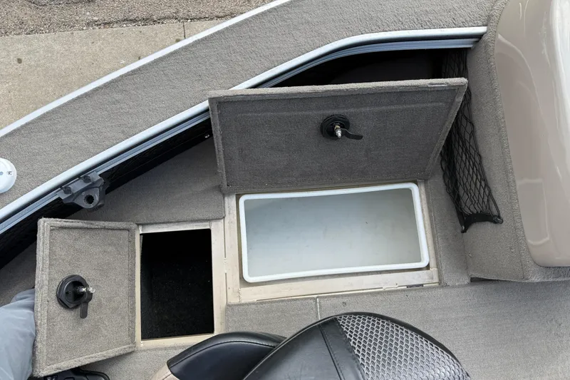 Slide: The Image of 2013 G3 Angler V185 SF boat storage compartments with open lids and seating area. - 14