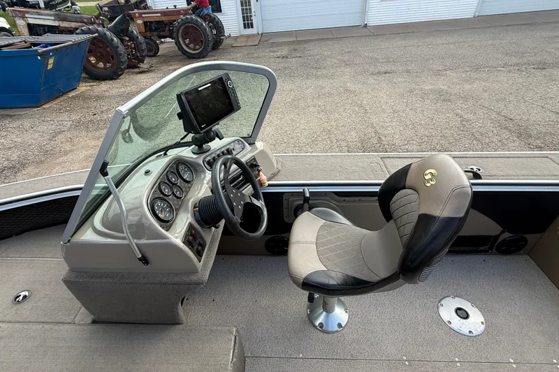 Slide: The Image of 2013 G3 Angler V185 SF boat interior with steering console and cushioned seat. - 23