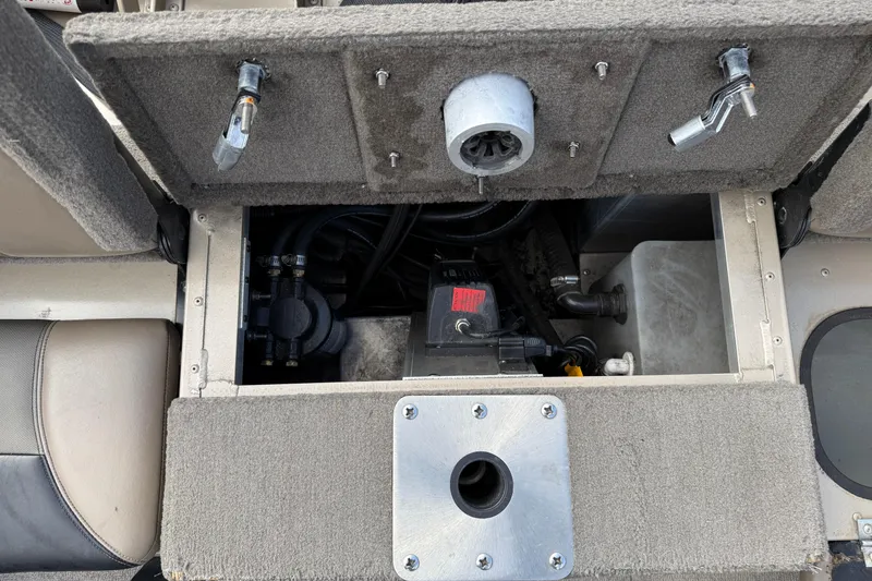 Slide: The Image of Open storage compartment in 2013 G3 Angler V185 SF boat, showing internal components and wiring. - 29