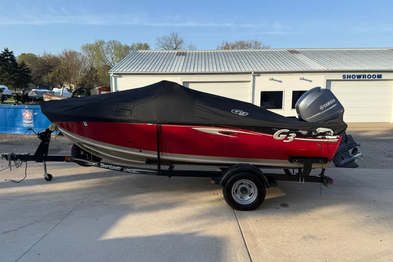 Slide: The Image of 2013 G3 Angler V185 SF boat with cover on trailer, parked outside showroom. - 33