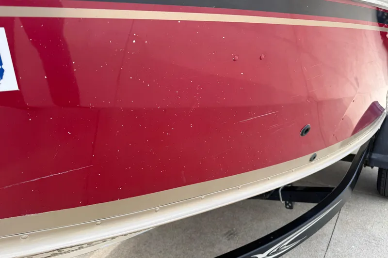 Slide: The Image of Red 2013 G3 Angler V185 SF boat hull with visible scratches and trailer. - 36
