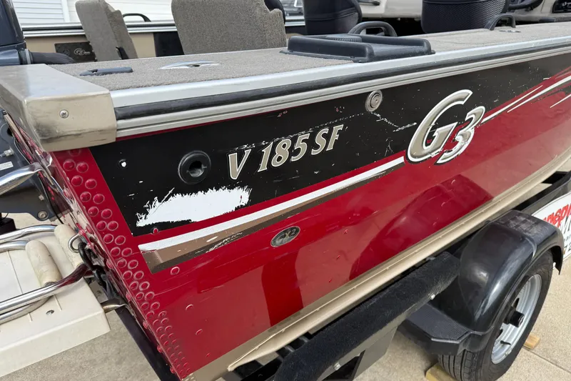 Slide: The Image of 2013 G3 Angler V185 SF boat with red and black exterior detailing. - 37