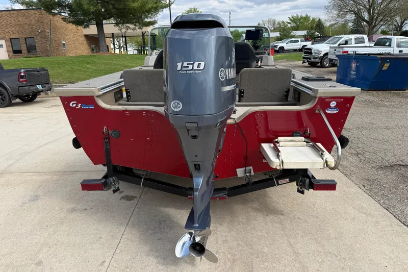 Slide: The Image of 2013 G3 Angler V185 SF boat with Yamaha 150 engine, parked outdoors. - 5