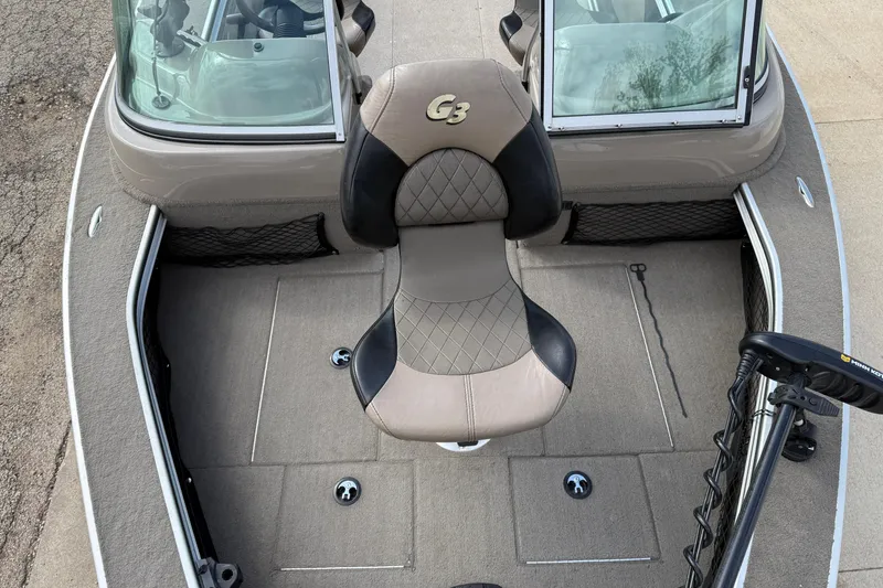 Slide: The Image of 2013 G3 Angler V185 SF boat interior with cushioned seat and carpeted flooring. - 9