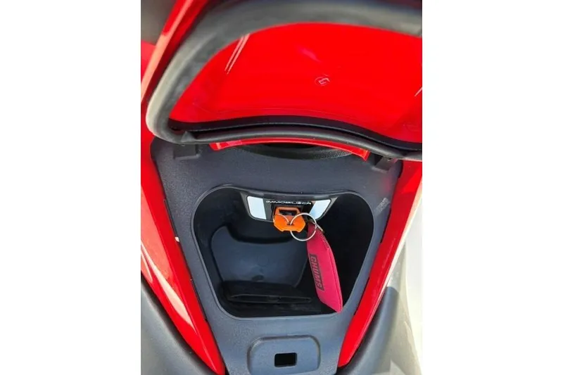 Slide: The Image of 2012 Kawasaki Jetski Ultra LX storage compartment with red interior and key fob. - 14