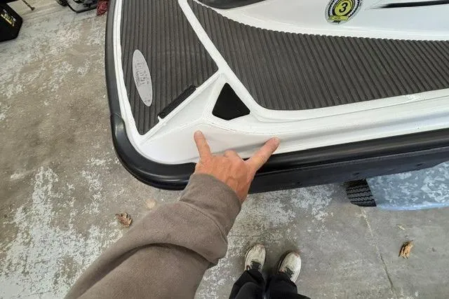 Slide: The Image of 2012 Kawasaki Jetski Ultra LX rear deck with person pointing at detail. - 16