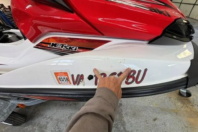 Slide: The Image of 2012 Kawasaki Jetski Ultra LX with registration sticker and hand pointing at hull. - 17