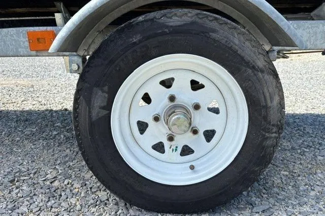 Slide: The Image of Trailer wheel for 2012 Kawasaki Jetski Ultra LX on gravel surface. - 4