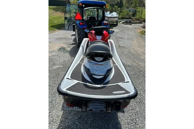 Slide: The Image of 2012 Kawasaki Jetski Ultra LX on gravel path, parked behind a blue tractor. - 5