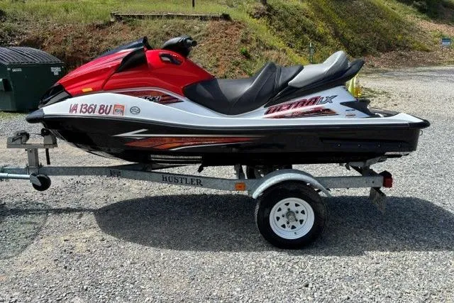 Slide: The Image of 2012 Kawasaki Jetski Ultra LX on trailer, parked outdoors on gravel. - 6